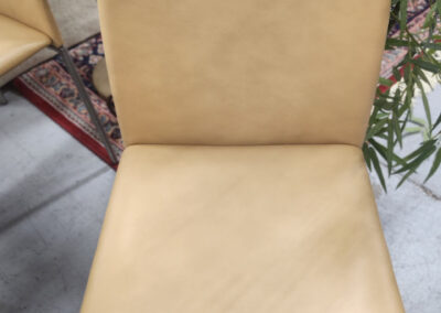 Beige leather dining chair with metal legs
