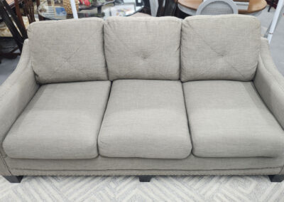 Light gray three-seater upholstered sofa