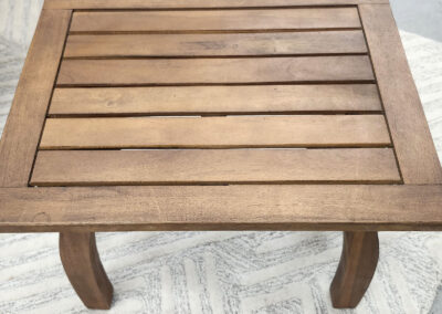 Square wooden slatted side table on rug