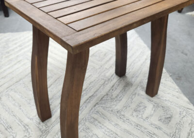 Wooden slatted side table with curved legs