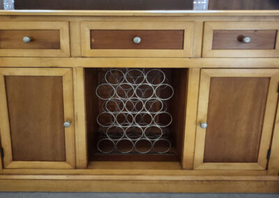 Wooden sideboard with central wine rack