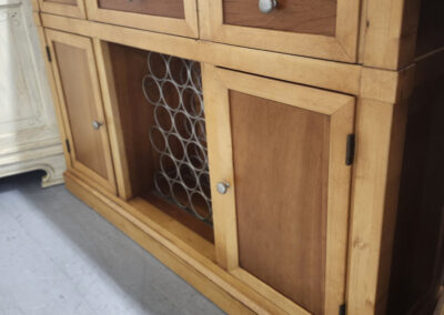 Wooden sideboard with central wine rack