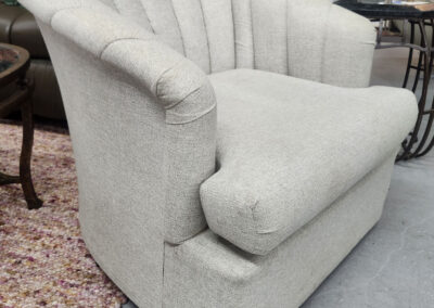 Light gray upholstered shell-back armchair