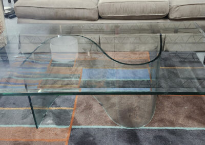 Rectangular glass coffee table between upholstered sofas