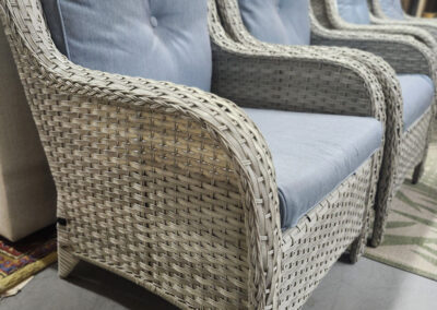Three wicker armchairs with light blue cushions