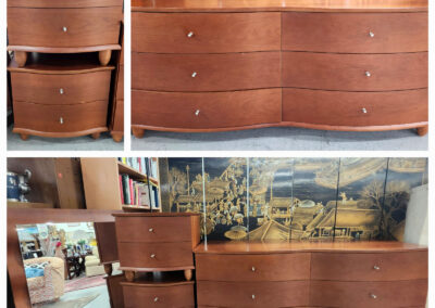 Curved wooden dresser with silver knobs