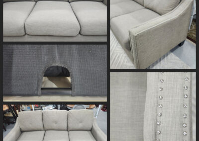 Light gray three-seater sofa with nailhead trim