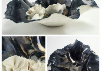 Black ruffled ceramic bowl with white porcelain flowers
