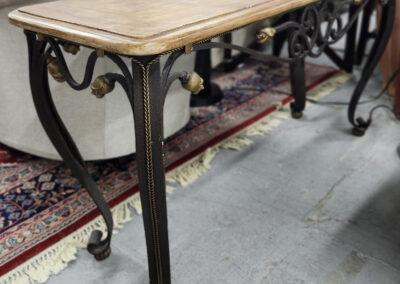 Ornate iron-legged console table with wood top