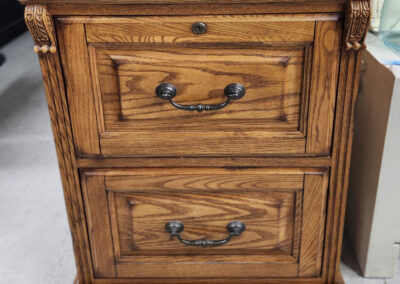 Oak two-drawer wooden nightstand with brass handles