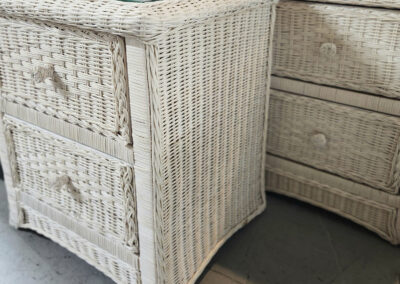 White wicker bedside tables with glass tops