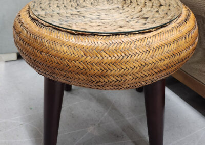 Round woven rattan stool with dark legs