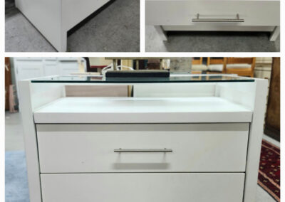 White two-drawer nightstand with glass top