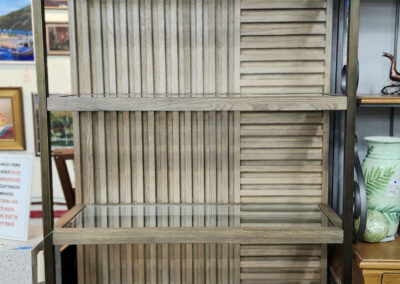 Tall rustic wooden bookshelf with slatted back