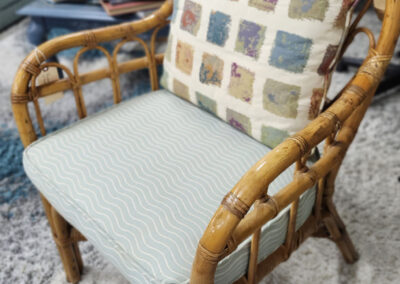 Rattan armchair with patterned cushions in living room