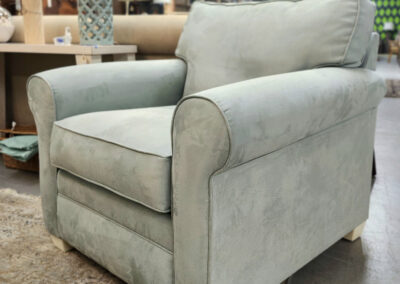 Light green upholstered armchair in showroom