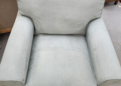 Light blue upholstered armchair on rug