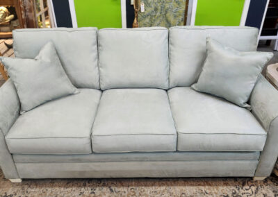 Light gray upholstered three-seat sofa