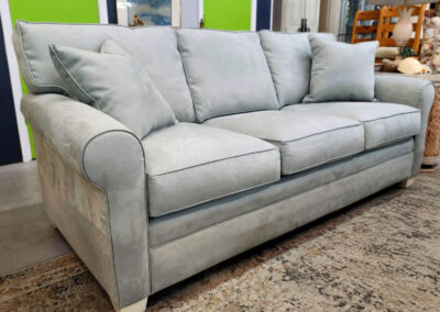 Light gray three-seater upholstered sofa