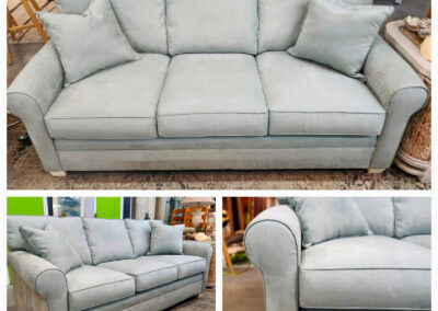 Light blue upholstered sofa with two pillows