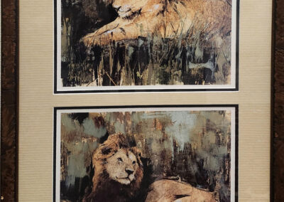 Framed artwork of two reclining lions