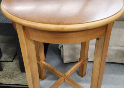 Round wooden side table with cross legs