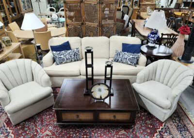 Cream sofa and chairs with wooden coffee table