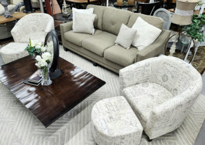 Beige sofa and patterned chairs with coffee table