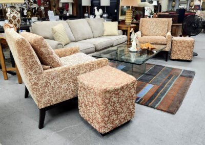 Patterned armchairs and sofa around glass table