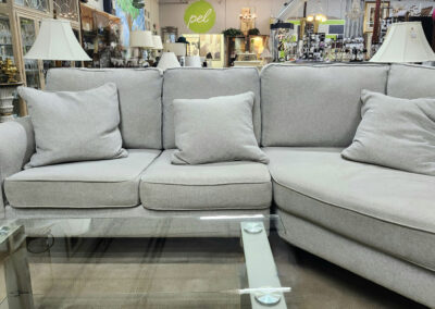 Light gray sectional sofa with cushions
