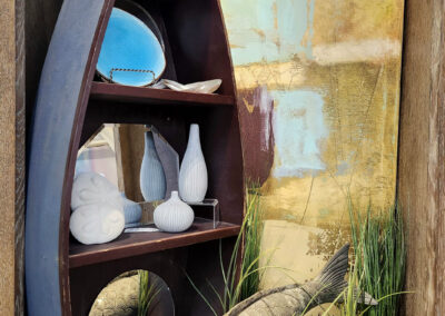 Wooden boat shelf with fish sculpture and ceramics