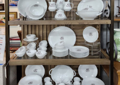 White dishware set displayed on wooden shelves