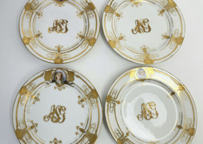 Set of four ornate porcelain plates with portraits