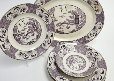 Purple transferware plates with oriental landscape pattern