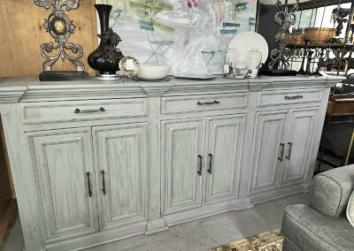 Distressed white wooden sideboard with decor